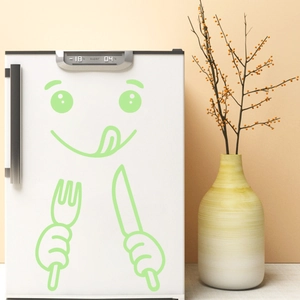 Luminous green cartoon face fridge sticker with fork and knife on a white refrigerator