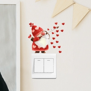 Macro view of romantic gnome wall stickers with hearts applied on a white light switch