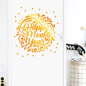 Close-up of golden Happy New Year wall sticker with artistic gradients on a white door