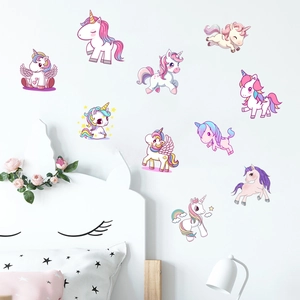 Detailed view of colorful unicorn wall decals decorated in a cozy child's bedroom setting