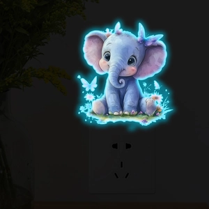 Blue watercolor elephant wall light glowing in a dark room setting for home decor