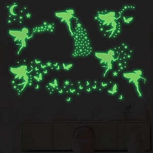 Luminous wall stickers showing glowing fairy, moon and stars in dark green fluorescence