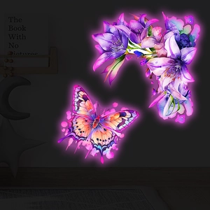 Close-up of luminous watercolor butterfly and lily wall stickers with pink neon glow