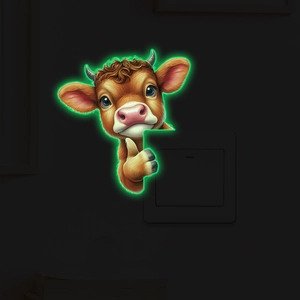 Luminous cartoon cow wall sticker showing green glow effect around light switch cover