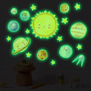 Luminous solar system wall decals glowing in a cozy dark children's bedroom setting
