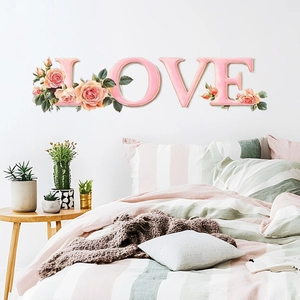 Detailed close-up of pink rose floral LOVE wall stickers in a cozy bedroom decor setting