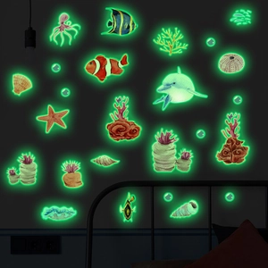 Luminous ocean creature wall stickers showing dolphins and fish glowing in a dark room