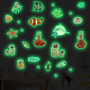 Luminous ocean creature wall stickers showing glowing green dolphin and fish in dark room