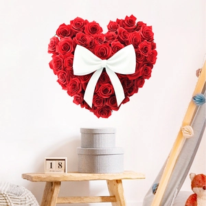 Detail of red rose heart-shaped wall sticker with a large white 3D ribbon bow decoration