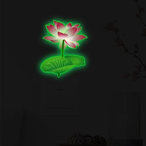 Luminous lotus wall sticker showing pink flower and green leaves glowing in dark room