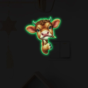 Luminous highland cow wall sticker showing green glow in the dark for light switches