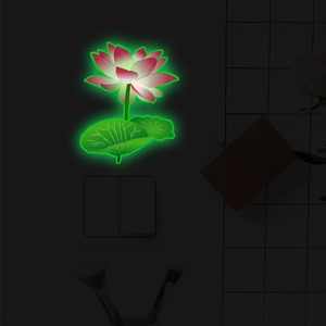 Detailed close-up showing the green glow effect of the lotus wall sticker in the dark