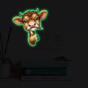 Luminous highland cow wall sticker showing glowing green effect above light switch