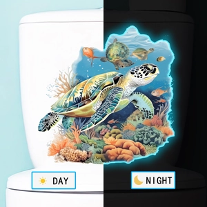 Glow in the dark sea turtle bathroom stickers showing day and night fluorescence effects