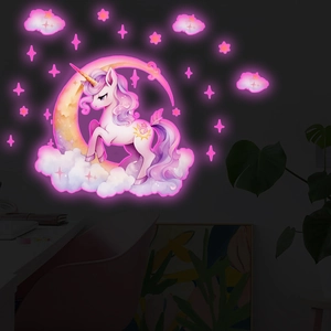Luminous unicorn and moon wall decals glowing in dark room for nursery decoration