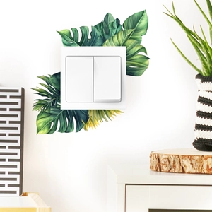 Detail of tropical monstera leaves wall stickers around home light switch plate