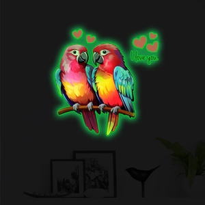 Luminous wall sticker showing two colorful parrots on a branch with neon glowing edges
