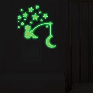 Luminous wall sticker showing a silhouette boy fishing on a moon with glowing stars