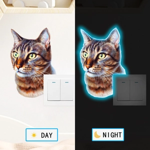 Luminous cat switch sticker showing day and night glowing effect in a side-by-side view