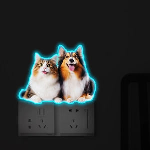 Luminous wall sticker showing a glowing blue neon cat and dog silhouette above a power outlet
