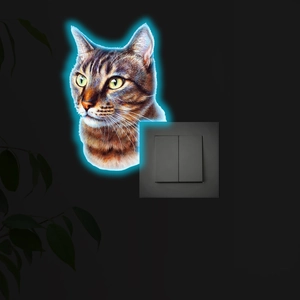 Luminous tabby cat sticker with blue neon glow detail near a black wall light switch