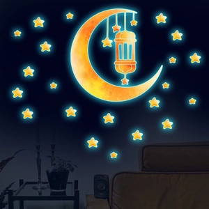Close-up of glowing blue crescent moon and stars wall decals in a dark room setting