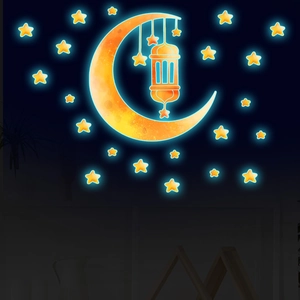 Luminous Ramadan moon and star wall stickers with Islamic lantern on smooth blue surface