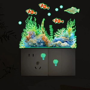 Glow-in-the-dark ocean animal wall stickers with luminous coral and fish around a socket