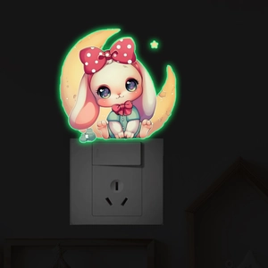 Luminous wall sticker showing a cute rabbit on a moon with glowing green stars at night