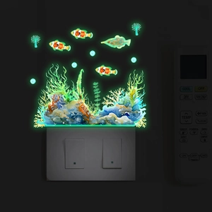 Luminous marine life wall stickers showing clownfish and coral glowing in the dark room