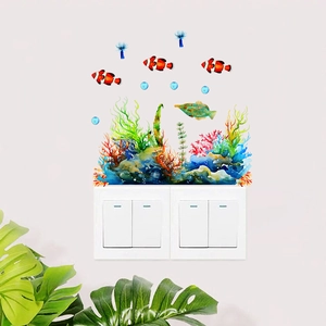 Luminous marine life wall stickers featuring watercolor clownfish and coral reef decor