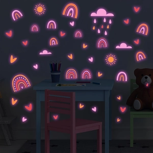 Glow-in-the-dark wall stickers featuring pink rainbow and sun patterns in kids room