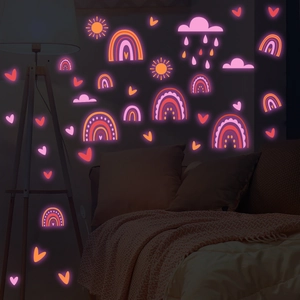 Luminous wall stickers with pink moon and rainbow glowing in a dark kid's bedroom