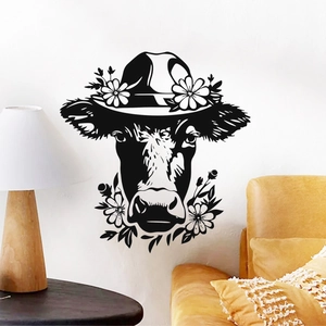 Detail view of black silhouette cow head wall sticker with floral hat in a cozy living room