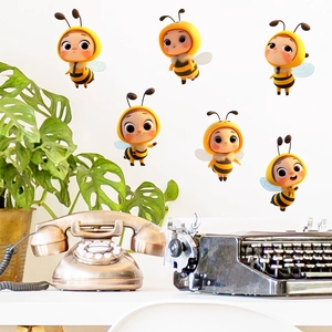 Close-up of six creative glow-in-the-dark 3D cartoon bee wall stickers on a white surface