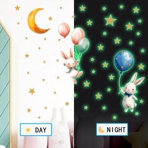 Luminous bunny and balloon wall stickers showing day vs night glow-in-the-dark effect