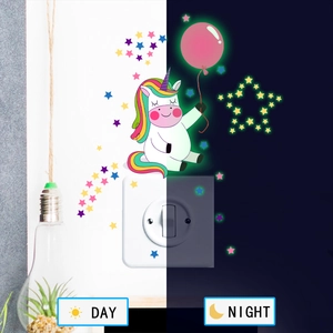Glow-in-the-dark luminous unicorn and balloon wall sticker shown in day and night effect
