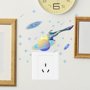 Luminous blue galaxy and planet wall stickers applied around a white light switch panel