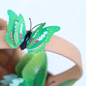 3D butterfly wall decor in green and yellow on a wooden handle with white background
