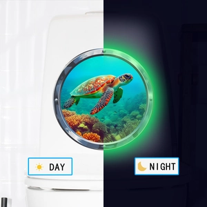 Luminous sea turtle bathroom sticker showing daytime detail and green glow at night