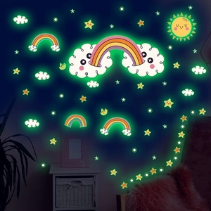 Luminous rainbow and clouds wall stickers glowing green in a dark kid's bedroom