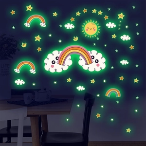 Luminous rainbow wall stickers with glowing stars and clouds in a dark kids room decor