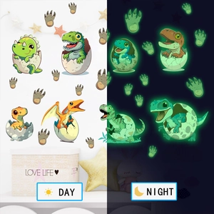 Luminous cartoon dinosaur wall stickers showing day and night glow effect in children's room