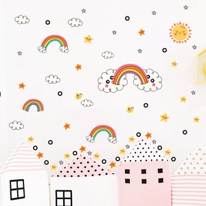 Close-up of rainbow and sun luminous wall stickers in a cozy nursery room setting