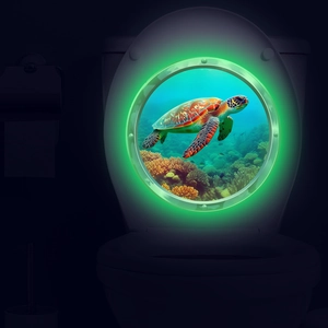 Glow-in-the-dark turtle ocean submarine window sticker on a white toilet lid