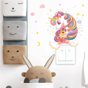 Detailed view of pastel unicorn wall stickers with stars and moon on a white wall
