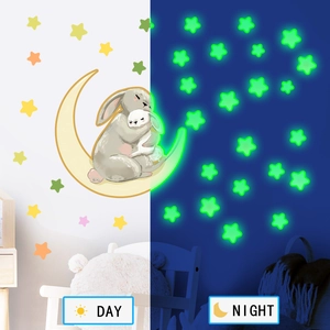 Luminous wall sticker showing bunny on moon with stars in day and night contrast