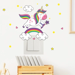 Detailed view of unicorn and rainbow glow stickers applied above a home light switch