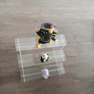 Macro view of three-tier clear acrylic display stand with steps for toy collection