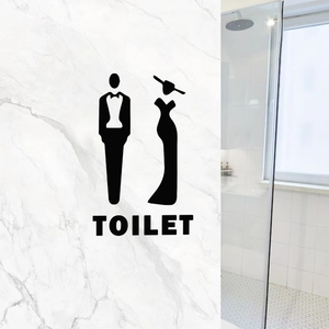 Creative toilet sign decal featuring gentleman and lady silhouettes on white marble wall